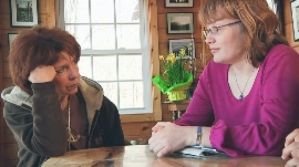 Kit Gruelle and Deanna Walters meeting at Kit's cabin in a scene from Private Violence
